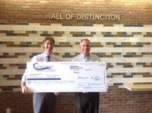 Carlsbad Dentist, Dr. Brandon Bell, presenting Boys and Girls Club of Carlsbad CEO Brad Holland with a donation
