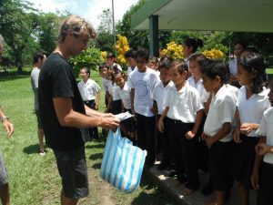 Dr. Brandon Bell distributing donated toothbrushes to local schools in Costa Rica