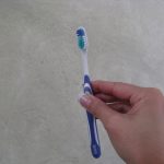 Holding a toothbrush like a champagne glass